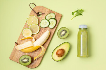 Healthy fresh avocado, kiwi, banana and cucumber green smoothie with assorted ingredients. Superfood detox and diet concept. Top view, flat lay