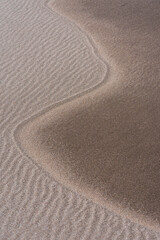 Fototapeta na wymiar Wavy line on the sand of the beach, produced by the action of the wind.