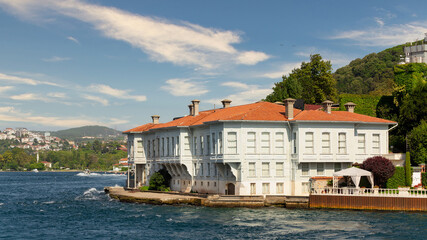 View from Bosphorus strait of the green mountains of the Asian side, with traditional houses and dense trees in a summer day, Istanbul, Turkey
