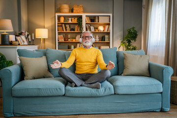 Obraz premium Mature senior man practice guided meditation manifestation at home