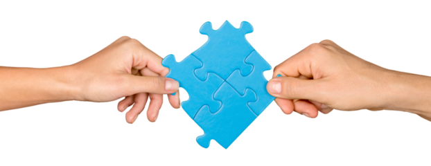 Closeup on Hands Combining Puzzle Pieces Together