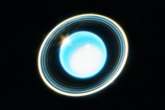 The planet Neptune, on a dark background with rings. Elements of this image furnished NASA.