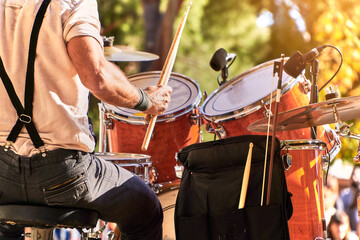 Summer music festival at the park. Close up of drummer playing on the stage