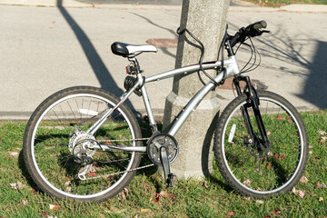 Bicycle leaning against a pole and locked