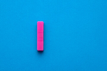 Alphabet letter I - Pink plastic piece on blue foamy background