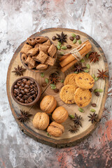 top view sweet biscuits with coffee and walnuts on light background sugar tea color cookie sweet cocoa