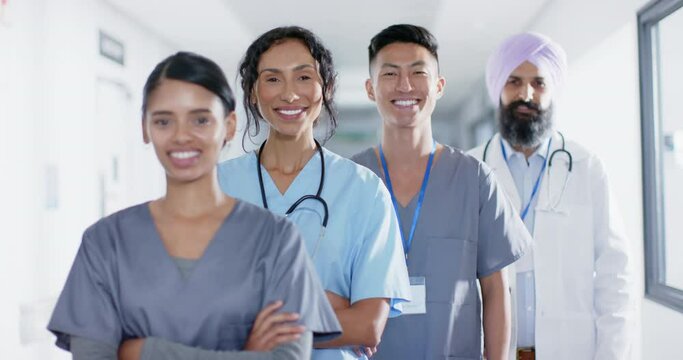 Portrait of diverse doctors and nurses smiling in corridor at hospital, in slow motion