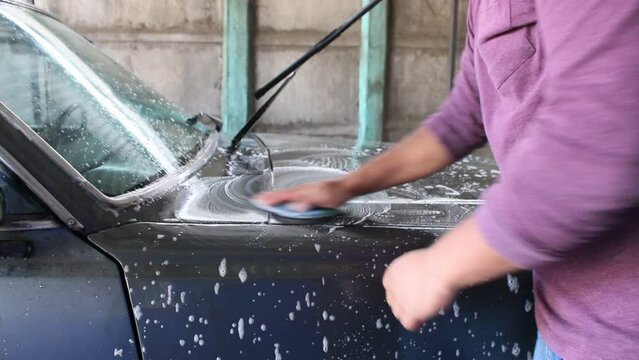 latina person washing a car