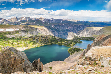 Naklejka na ściany i meble Twin Lakes in the alpine high mountain landscape of Beartooth Mountain Range in Montana with blue sky and white clouds.