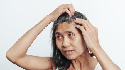 Close up older elderly asian chinese woman gray hair worry cancer worry about hair loss