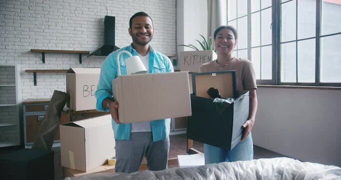 Married man and woman enjoy moving to spacious house