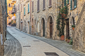 Italy, Umbria. Street leading up to the main square in the historic town of Montone. - obrazy, fototapety, plakaty