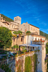 Fototapeta na wymiar Italy, Umbria. Evening light on flower covered buildings overlooking the medieval town of Gubbio.