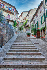 Italy, Umbria. Stairs leading up with flowers decorating the homes in the historic town of Montone.