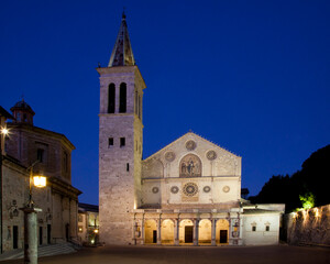 Fototapeta na wymiar Italy, Umbria. Evening view of the Duomo in the Romanesque town of Spoleto. (Santa Maria Assunta Cathedral).