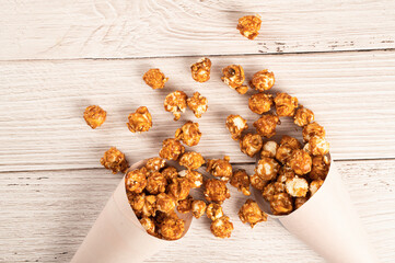 Top view of Caramel popcorn on wooden table background