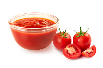 Glass bowl of tomato sauce with fresh tomato on white