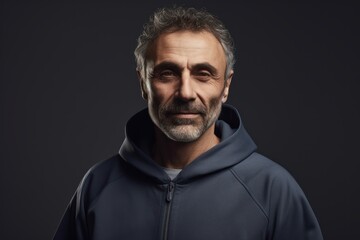 Portrait of handsome mature man with grey hair in hoodie.
