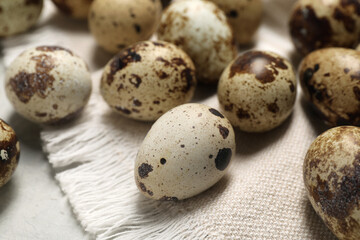 Many speckled quail eggs on table, closeup