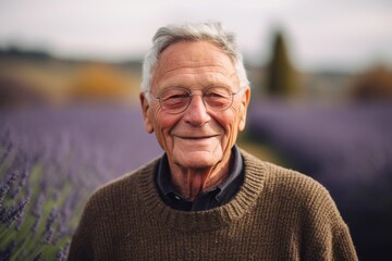 Portrait of a senior man standing in a lavender field.