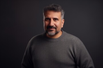 Fototapeta premium Portrait of a handsome middle-aged man on a dark background