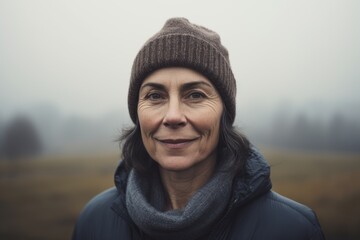 Portrait of a senior woman in the middle of a foggy field