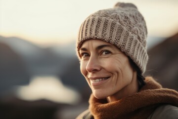 Portrait of a smiling mature woman in winter hat and scarf outdoors