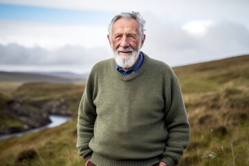 Senior man standing in a field on the Isle of Skye, Scotland