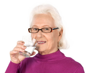 Portrait of smiling old woman wearing glasses and holding a glass of water, isolated