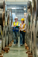 Man mentor teaching trainee woman engineer technician inspection and use clipboard check Inventory...