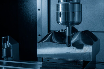 Close up scene the CNC milling machine rough cutting the mold parts by indexable ball tools.