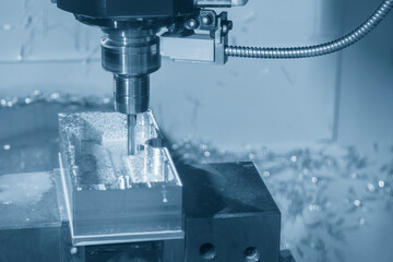 The CNC milling machine rough cutting the aluminum housing with flat end mill tool.