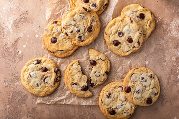Chocolate chip cookies with flaky salt on parchment paper