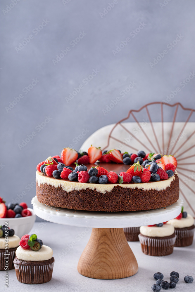 Wall mural Chocolate and vanilla cheesecake with summer berries