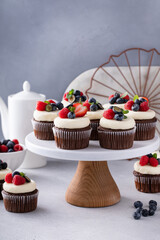 Chocolate cupcakes with cream cheese frosting and fresh berries