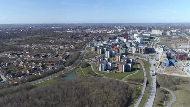 Aerial backward shot of brunnshög, high angle with lund and malmö in background, Sweden