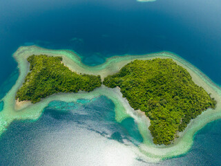 Aerial drone of tropical island and coral atoll with turquoise water. Seascape in the tropics....