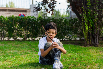 Young boy alone. having fun in a park.