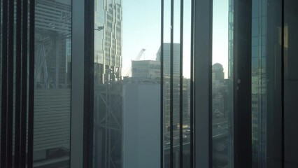 inside moving up down elevator lift in major department store in Tokyo in winter daytime