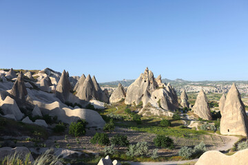 Mountainous landscape with cone-shaped rocks under blue sky