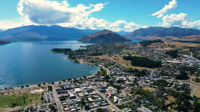 Aerial flying forward over Wanaka in sunny day, New Zealand