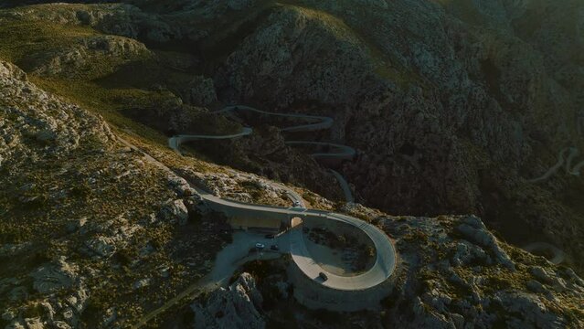 Hairpin Bend Sa Calobra at Palma de Mallorca Island. Serpentine curve road in the mountains near Soller. Scenic Majorca nature aerial drone footage. Famous for racing bikes cycling. Cinematic 4K UHD.