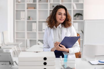 Young female doctor at workplace in clinic