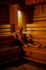 Man in hot sauna alone wood relaxing meditation terapy