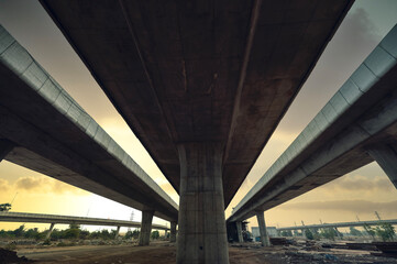 Construction of asphalt highways and overpasses in Asia, view of road junction against the sky