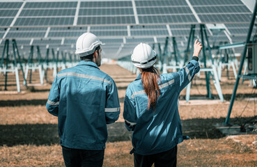 Solar design engineers visually inspect photovoltaic array installation sites for suitable...