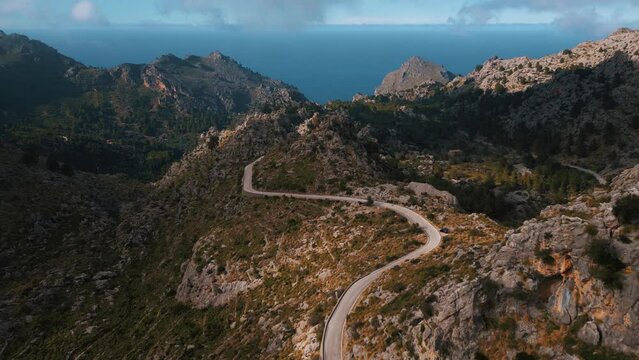 Sa Calobra, Palma de Mallorca. Serpentine curve road with Hairpin Bend at mountains near Soller. Scenic Majorca Island nature aerial drone footage. Famous for racing bikes bicycles. Cinematic 4K UHD.