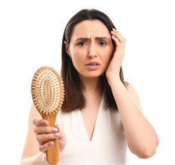 Worried young woman with hair loss problem on white  background