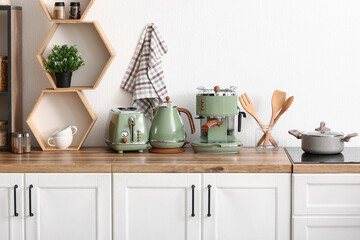 Coffee machine, toaster and electric kettle on kitchen counter