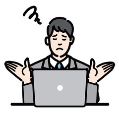 ラップトップの前で両手を上げて困っているスーツを着た若い男性
